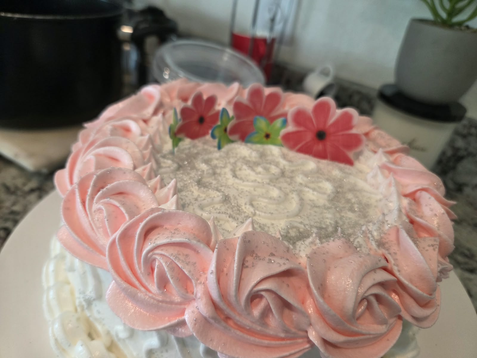 Pink cake with flowers and butterflies from Cuban Cake’s catalog